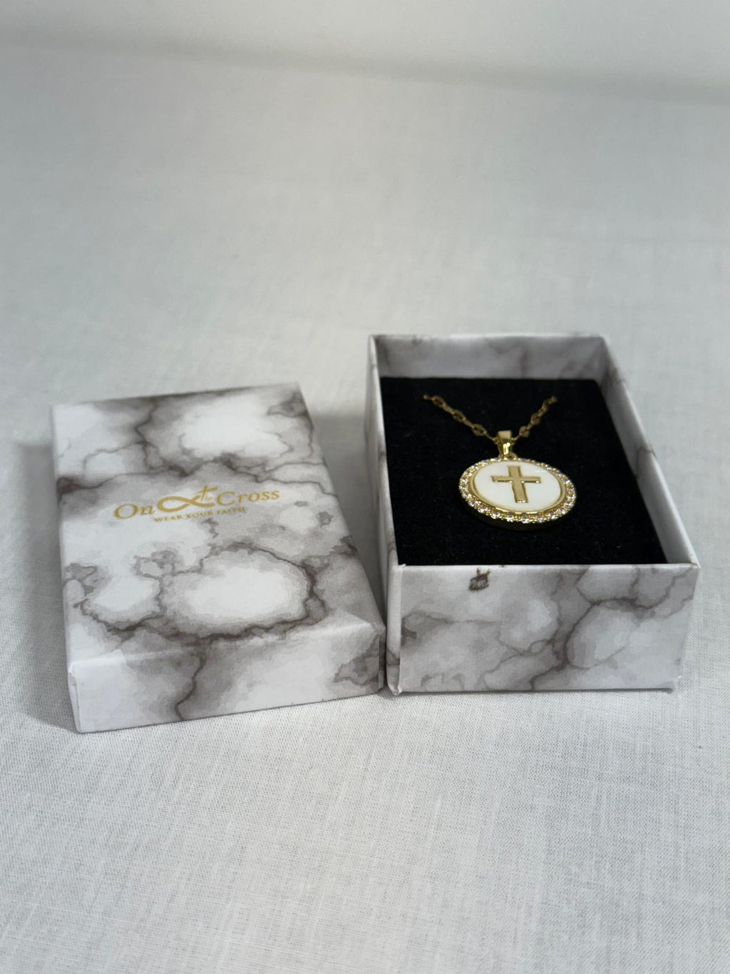 Woman’s Gold plated round cross pendant.